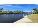 Picturesque waterfront view of lush landscaping and docks under a clear blue sky at 425 Belvedere Ct, Punta Gorda, FL 33950