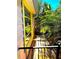 View of a back porch with yellow window trim and lush tropical foliage around the structure at 4344 Commercial St, Port Charlotte, FL 33953