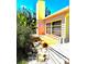 Exterior view of the home featuring a yellow chimney and lush tropical plants, adding to its charm at 4344 Commercial St, Port Charlotte, FL 33953