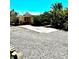 Home's exterior with stone driveway, lush greenery, and tropical plants in the front and side yards at 4344 Commercial St, Port Charlotte, FL 33953
