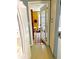 Hallway with wood floors offers a glimpse into other rooms, adding charm at 4344 Commercial St, Port Charlotte, FL 33953