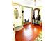 Inviting living room features hardwood floors, a decorative mirror, and natural light at 4344 Commercial St, Port Charlotte, FL 33953