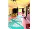 Bright living space featuring unique decor, pink floor, and tropical-themed rugs at 4344 Commercial St, Port Charlotte, FL 33953