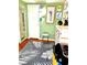 Cozy living space with green walls, artwork, and a vintage-style cabinet at 4344 Commercial St, Port Charlotte, FL 33953