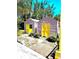 View of two matching outbuildings with vibrant yellow doors in a well maintained backyard at 4344 Commercial St, Port Charlotte, FL 33953