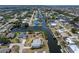 Aerial view of a waterfront property with canal access, featuring a private boat dock and lush tropical landscaping at 453 Carolyn Ln, Punta Gorda, FL 33950