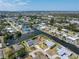 Aerial view featuring canal-front home on a large lot and a glimpse of the open sea at 453 Carolyn Ln, Punta Gorda, FL 33950