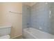 A cozy bathroom with blue-tiled shower and essential fixtures at 453 Carolyn Ln, Punta Gorda, FL 33950