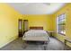 Large bedroom with bright yellow walls, carpet, and large window at 453 Carolyn Ln, Punta Gorda, FL 33950