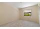 Neutral bedroom featuring a window with natural light and closet with paneled doors at 453 Carolyn Ln, Punta Gorda, FL 33950