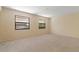 Bright bedroom featuring carpeted floors and dual windows offering natural light at 453 Carolyn Ln, Punta Gorda, FL 33950