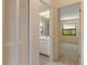 A hallway connecting a bathroom, closet, and a bedroom in the home at 453 Carolyn Ln, Punta Gorda, FL 33950