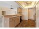 Well-lit kitchen area featuring brown tile floors and wooden cabinetry at 453 Carolyn Ln, Punta Gorda, FL 33950