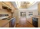 Galley kitchen with bright ceiling, white appliances, and a view of the screened-in pool area at 453 Carolyn Ln, Punta Gorda, FL 33950