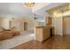 Open-concept kitchen and living room featuring a breakfast bar and ceiling fan at 453 Carolyn Ln, Punta Gorda, FL 33950