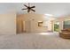 Open-concept living area with neutral carpet, vaulted ceiling, and seamless transition to the kitchen at 453 Carolyn Ln, Punta Gorda, FL 33950