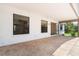 Spacious covered patio area featuring a stone-look concrete floor and access to the backyard at 453 Carolyn Ln, Punta Gorda, FL 33950
