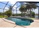 Screened-in pool area with a stone patio, clear blue pool water, and tranquil water views at 453 Carolyn Ln, Punta Gorda, FL 33950