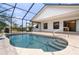 Inviting pool area with stone pavers, steps leading into the water, and a scenic backyard view at 453 Carolyn Ln, Punta Gorda, FL 33950