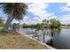 Waterfront view with wooden dock and metal chairs; perfect for relaxing and enjoying the scenery at 453 Carolyn Ln, Punta Gorda, FL 33950