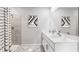 Bright bathroom featuring double sinks, a large mirror, and a tiled shower with a striped curtain at 4960 Tuscola Blvd, North Port, FL 34287
