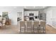 Modern kitchen boasts white cabinets, a breakfast bar with seating, and stainless steel appliances at 4960 Tuscola Blvd, North Port, FL 34287