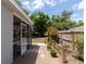 Backyard view featuring a screened patio, mature landscaping, and a spacious yard at 5333 Simrak St, North Port, FL 34287