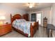 Bright bedroom featuring a decorative bedspread, wood furniture and access to the outside at 5333 Simrak St, North Port, FL 34287