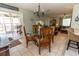 Elegant dining area with glass table, leading into screened patio and living room at 5333 Simrak St, North Port, FL 34287
