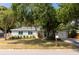 Charming single-story home featuring a well-maintained lawn and beautiful mature trees at 5333 Simrak St, North Port, FL 34287