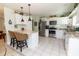 Modern kitchen featuring white cabinets, stainless steel appliances, and granite countertops at 5333 Simrak St, North Port, FL 34287