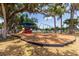 Neighborhood playground with slides, swings, and a protective mulch base under the shade of mature trees at 5333 Simrak St, North Port, FL 34287