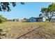 Wide view of backyard and light blue home at 5520 Kenwood Dr, North Port, FL 34287