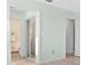 Bright bedroom with bathroom featuring mirrored closet doors and light wood flooring at 5520 Kenwood Dr, North Port, FL 34287