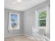 Light and airy bedroom with natural light streaming through two windows at 5520 Kenwood Dr, North Port, FL 34287