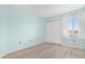 Bedroom with fresh blue walls, closet, and window with light filtering shades at 5520 Kenwood Dr, North Port, FL 34287