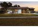 Charming single-story home with well-maintained lawn and tidy landscaping, creating great curb appeal at 5520 Kenwood Dr, North Port, FL 34287