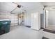 Spacious garage with white refrigerator, and garage door at 5520 Kenwood Dr, North Port, FL 34287