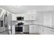 Modern kitchen featuring stainless steel appliances, white cabinets, granite countertops, and gray subway tile backsplash at 5520 Kenwood Dr, North Port, FL 34287