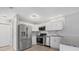 Modern kitchen featuring stainless steel appliances, white cabinets, and granite countertops at 5520 Kenwood Dr, North Port, FL 34287