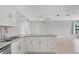 Open kitchen featuring an island with granite countertops and white cabinetry at 5520 Kenwood Dr, North Port, FL 34287