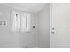 Clean laundry room with white appliances, window, and grey paint at 5520 Kenwood Dr, North Port, FL 34287