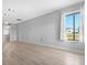 Bright living room featuring new hardwood floors, a large window, and neutral paint at 5520 Kenwood Dr, North Port, FL 34287