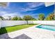 Landscaped backyard with well-maintained green grass and stone pavers around the fenced pool at 6245 Alhambra Ave, North Port, FL 34291