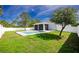 A backyard featuring well-maintained green grass, fenced in, with a screened in patio and pool at 6245 Alhambra Ave, North Port, FL 34291