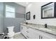 Stylish bathroom featuring a double vanity with granite countertops and modern fixtures at 6245 Alhambra Ave, North Port, FL 34291