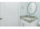 Bathroom vanity with granite countertop, updated fixtures, and a round mirror at 6245 Alhambra Ave, North Port, FL 34291