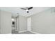 Bright room with modern ceiling fan, white trim, and light gray floors at 6245 Alhambra Ave, North Port, FL 34291