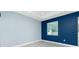 A well-lit bedroom with gray floors and a harmonious blend of light blue and navy walls at 6245 Alhambra Ave, North Port, FL 34291