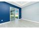 Empty bedroom showcasing recessed lighting, large window, and sliding door to back yard at 6245 Alhambra Ave, North Port, FL 34291